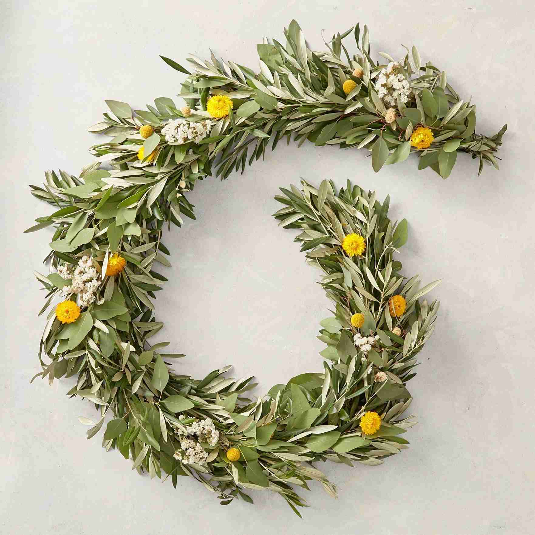 Olive and yellow-flowered live garland included in the spring mantel edit.