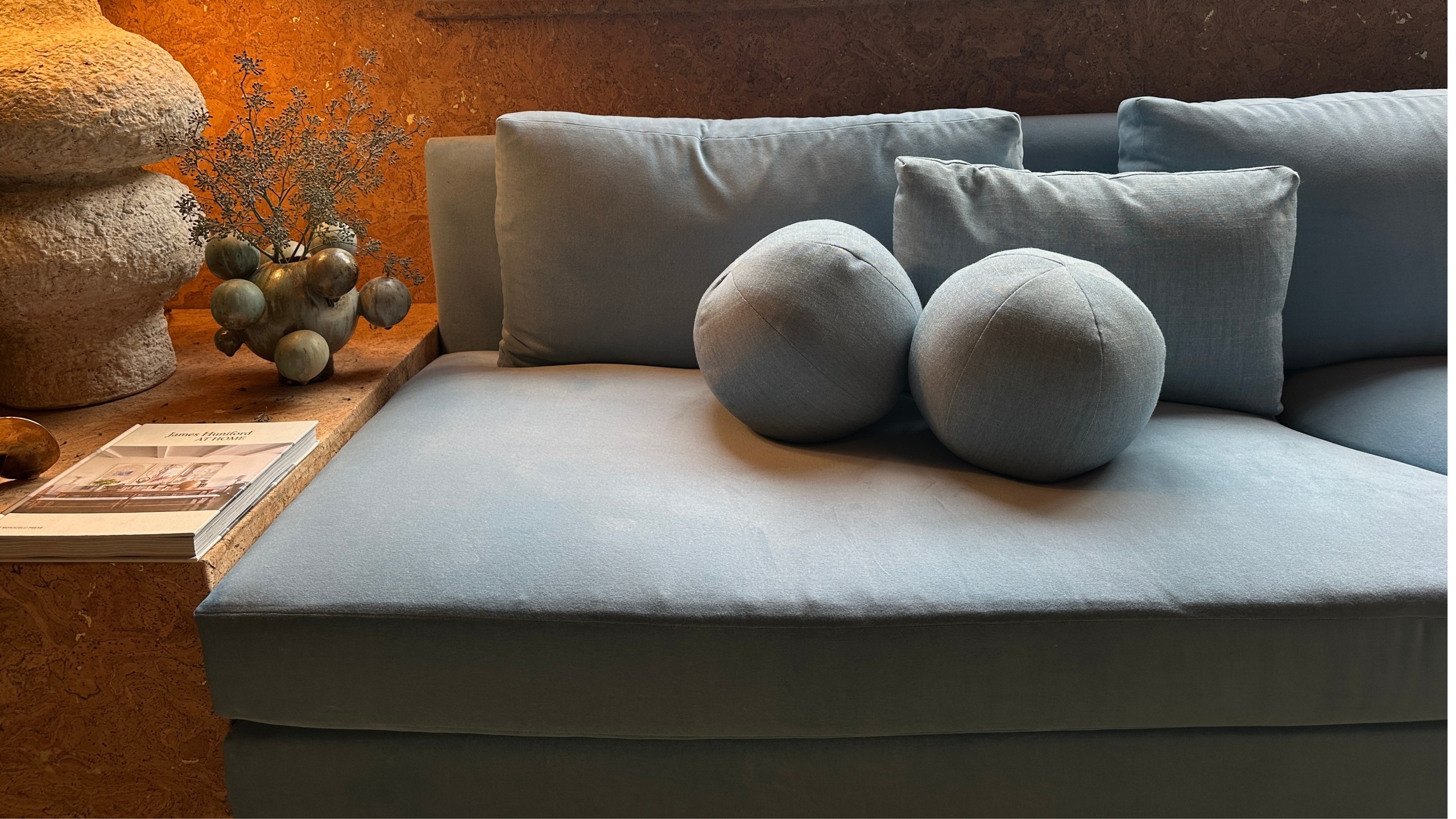 A Round Pillow Adds Shape to a Conventional Sofa