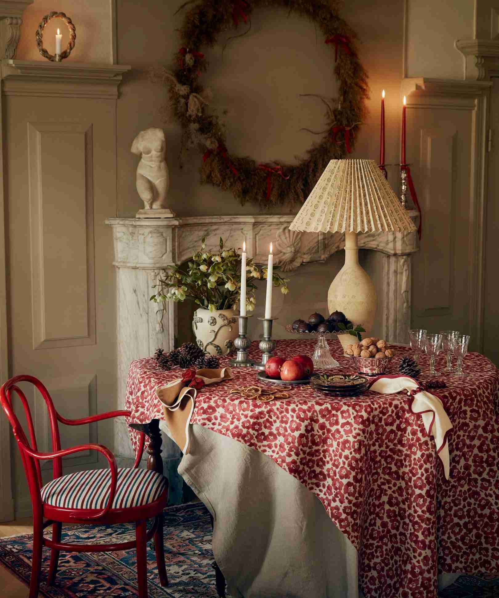 Christmas dining arrangement using a red cloth and natural green stems.