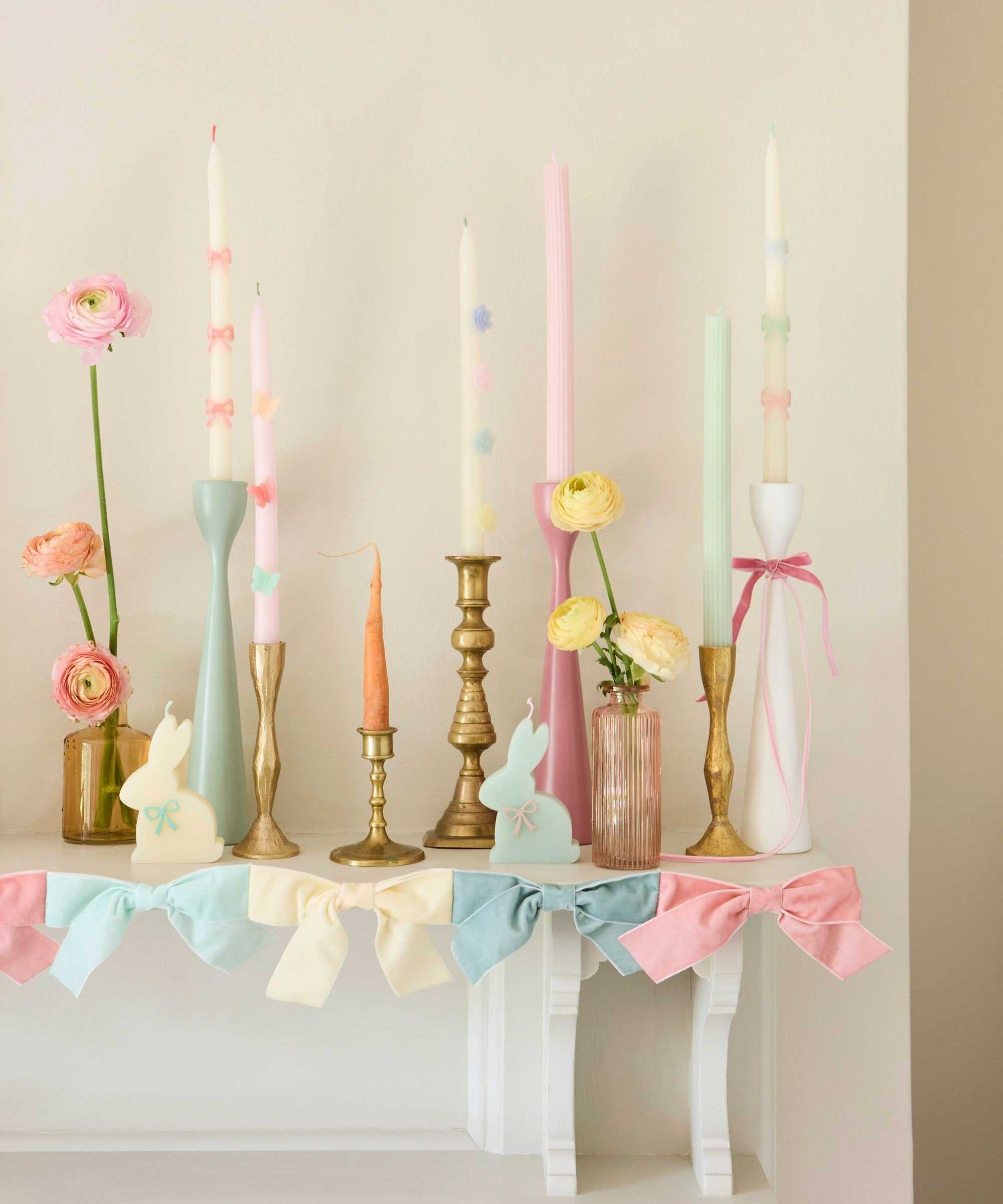 Easter mantel arrangement with pastel candles and ribbons.