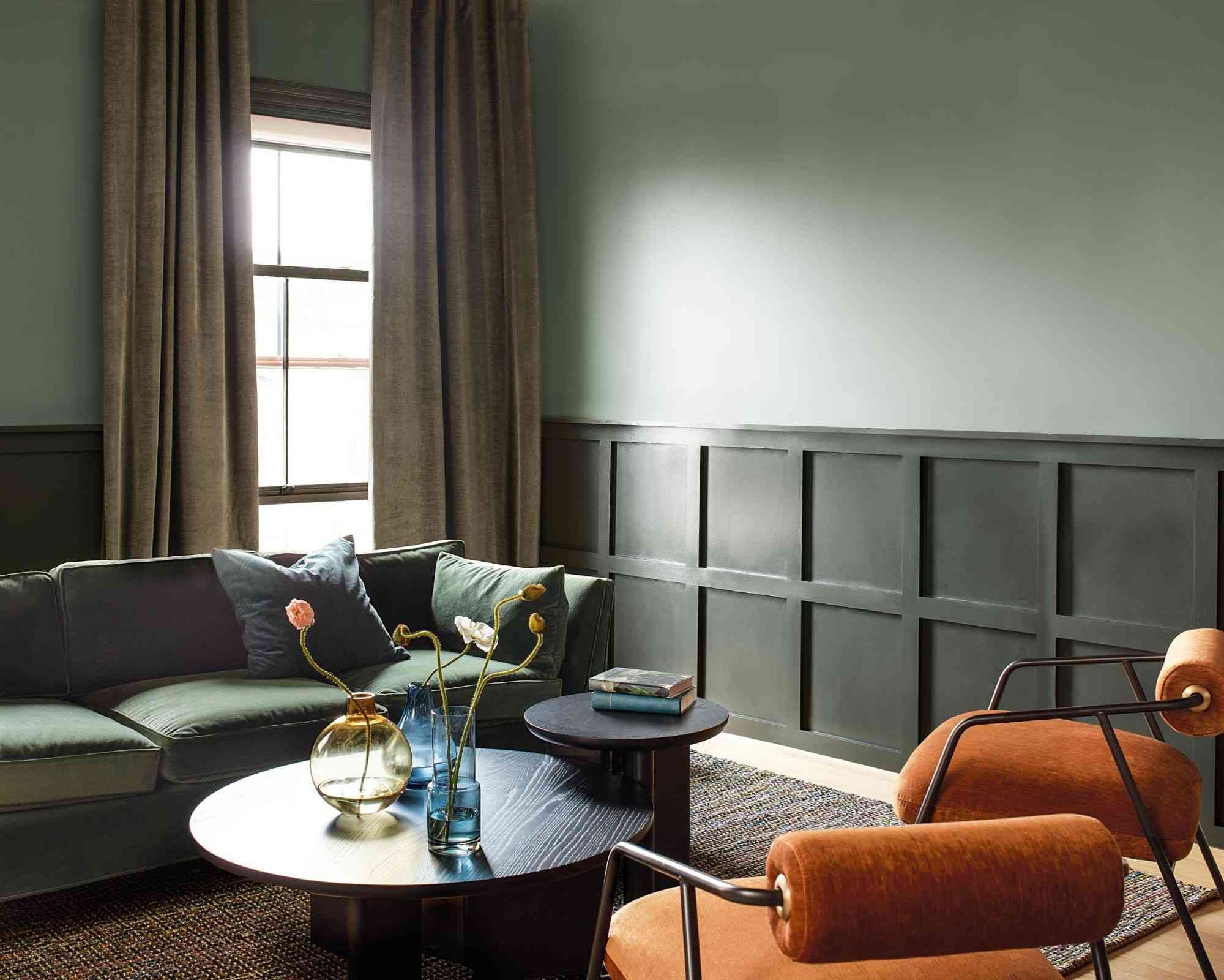 Living room combining lighter upper walls with darker green lower walls.